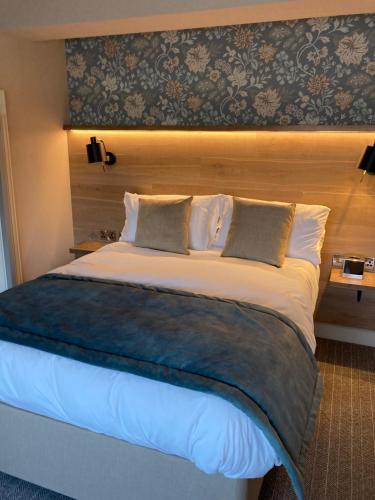 a bedroom with a large bed with a headboard at Duke of York in Whitby