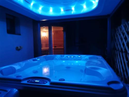 a bathroom with a tub with a blue light at Apartment Panorama Gerlitzen in Treffen