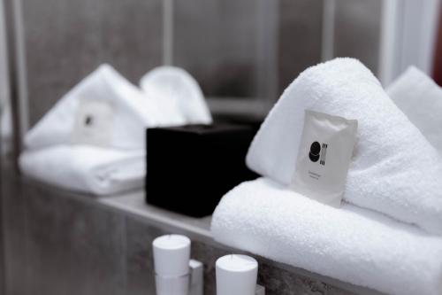 a pile of towels on a counter in a bathroom at Reos Hotel Wangen in Wangen im Allgäu