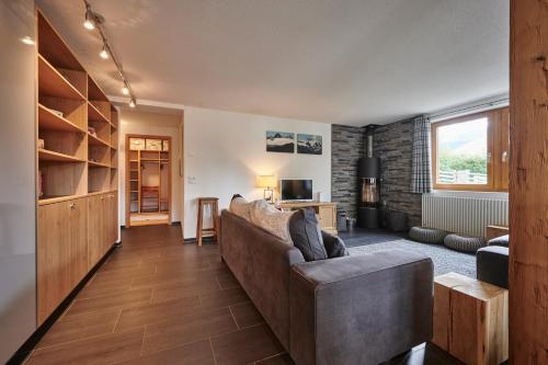 a living room with a couch and a table at Chalet Sole in Wengen