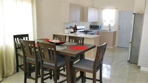 a kitchen and dining room with a table and chairs at Lux Sea View Camelot Village Discovery Bay in Discovery Bay