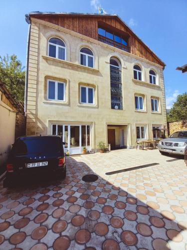 a car parked in front of a large house at Apart Hotel Sayat-Nova in Vanadzor
