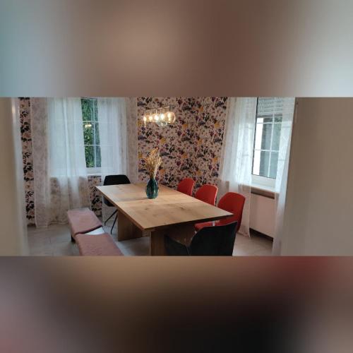 a dining room with a wooden table and chairs at Ferienvilla in Eppelborn