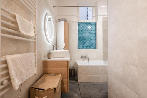 a bathroom with a sink and a bath tub at GoldenFeet Studio in Budapest