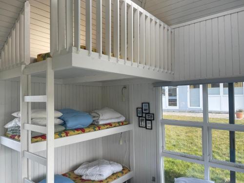 a room with two bunk beds and a window at Tisvildeleje Camping Hytter in Vejby