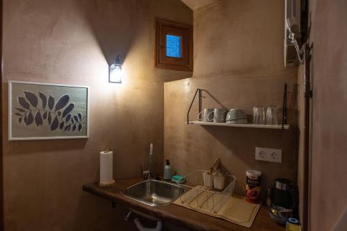 a kitchen with a sink and a counter top at The Fern House in Makrinítsa