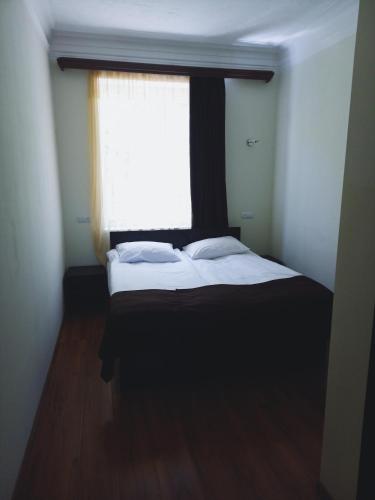 a bedroom with a large bed with a window at Apart Hotel Sayat-Nova in Vanadzor
