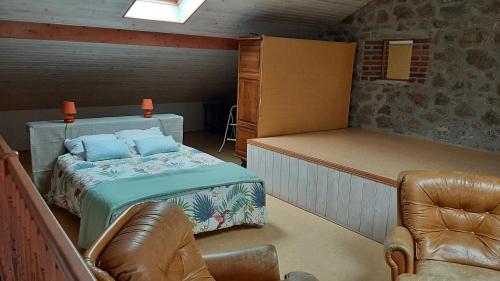 a bedroom with a bed and a couch and a chair at Charmant Logement T2 campagne 