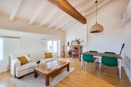 a living room with a couch and a table at Atico vistas Estafeta,centro historico in Pamplona