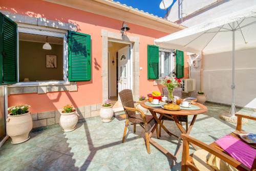 a patio with a table and chairs in front of a house at Xenia House in Gaios