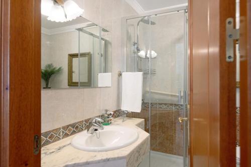 a bathroom with a sink and a shower at Alpispa in Arrecife