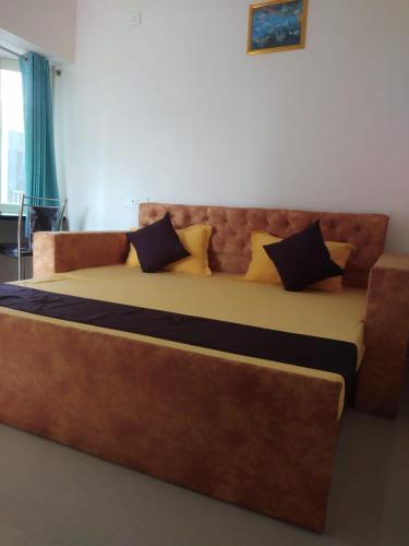 a large bed with pillows on it in a room at Krishnabalram wellness & Ayurveda centre in Rishīkesh