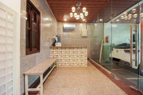 a room with a shower with a bench and a car at Urbanview Hotel Cantee Halim Perdanakusuma by RedDoorz in Jakarta