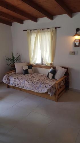 a large bed in a room with a window at Cabaña Don Suso in Paso de la Patria