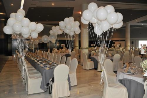 a banquet hall with white balloons and tables and chairs at Hotel Salobreña Suites in Salobreña