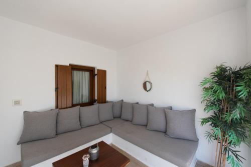a living room with a couch and a table at Edem Garden Residence in Platis Gialos
