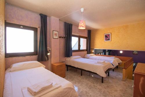 a hospital room with three beds and a window at Apartaments Turistics Natural Suites Manzano 3000 in Pas de la Casa