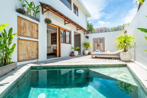 a swimming pool in the backyard of a house at Yume Villas in Uluwatu