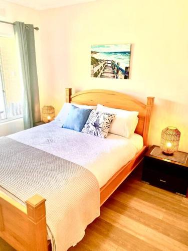 a bedroom with a large bed and a window at Victor Seaside Villa in Victor Harbor