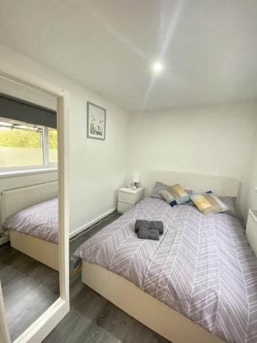 a bedroom with a large bed and a mirror at BEA Elcot Close in Manchester