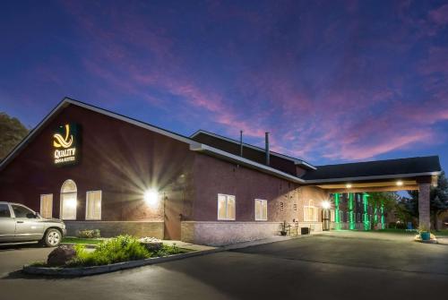a building with a car parked in a parking lot at Quality Inn & Suites Steamboat Springs in Steamboat Springs