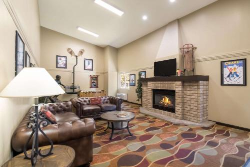 a living room with a couch and a fireplace at Quality Inn & Suites Steamboat Springs in Steamboat Springs