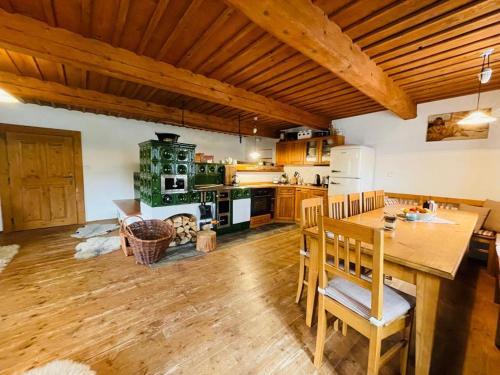 a kitchen with a wooden table and a dining room at SPA SPA - Roubenka in Jablonec nad Jizerou