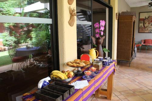 a table with a bunch of food on it at Hotel La Posada del Angel in San Salvador