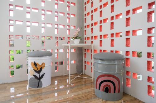 a room with two trash cans in front of a wall at RedDoorz Syariah near Universitas Tidar Magelang in Magelang