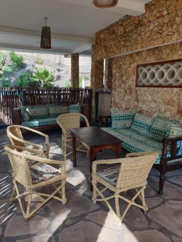 a patio with furniture and a table and chairs at Marijani Holiday Resort in Watamu