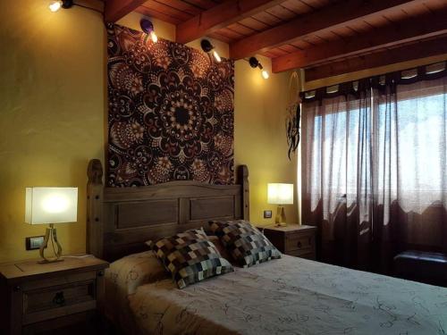 a bedroom with a large bed with two tables and two lamps at Apartamento rural zona céntrica isla in Puerto del Rosario