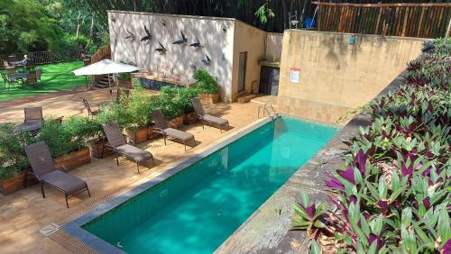 an overhead view of a swimming pool with chairs and a table at West Wood Hotel in Nairobi