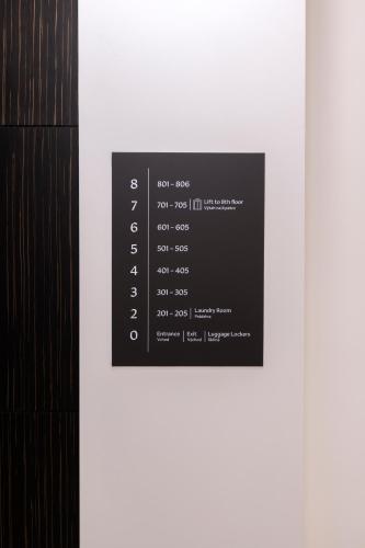 a label on a wall with numbers on it at Numa Prague Poise in Prague