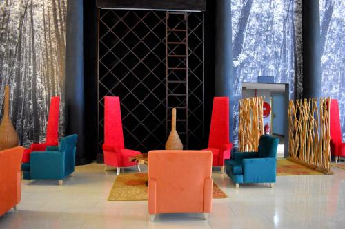 a lobby with colorful chairs and a table at West Wood Hotel in Nairobi