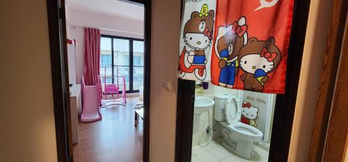 a bathroom with a hello kitty bathroom with a toilet at 樂南居 in Tainan