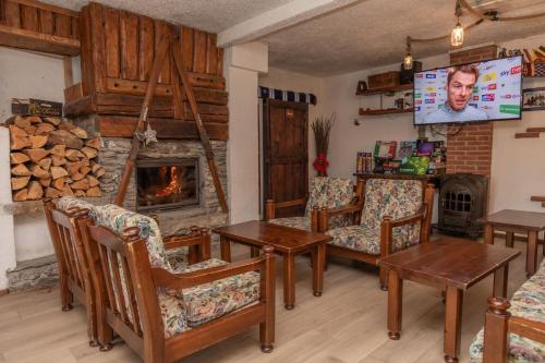 a living room with a fireplace and a tv at Hotel Martin in Sauze dʼOulx