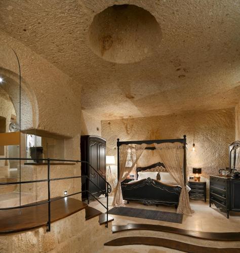 a bedroom with a bed with a mosquito net at Seraphim Cave Suites & SPA in Urgup