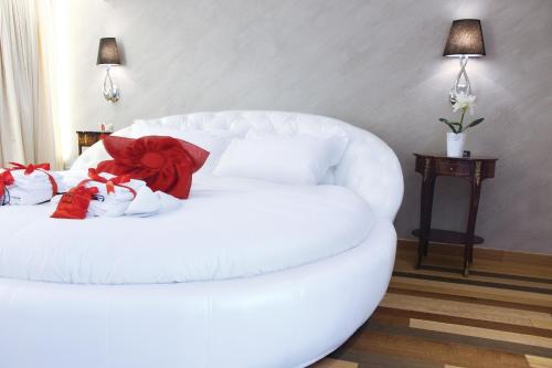 a white couch with red pillows on it in a room at Hub Navona in Rome
