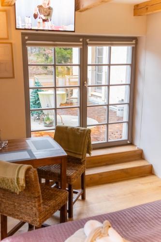 a room with a table and chairs and a window at Holzwerk Oybin in Kurort Oybin