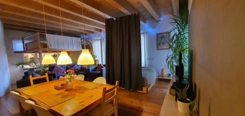 a living room with a table and a bedroom at Pension an der Elsterbrücke in Berlin