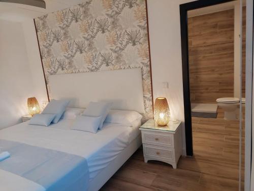 a bedroom with two beds with blue pillows at Hostal GARDEN ROUS in Paiporta