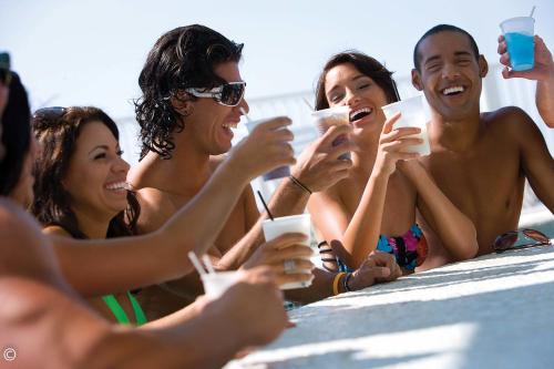 a group of people sitting around a table with drinks at Hotel Blue in Myrtle Beach