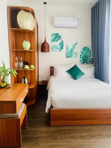 a bedroom with a bed and a book shelf at Hoi An Cabbage Garden in Hoi An