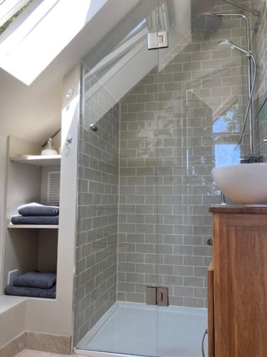 a bathroom with a shower and a sink at The Owl's Nest at Dunkirk Bank in Nailsworth