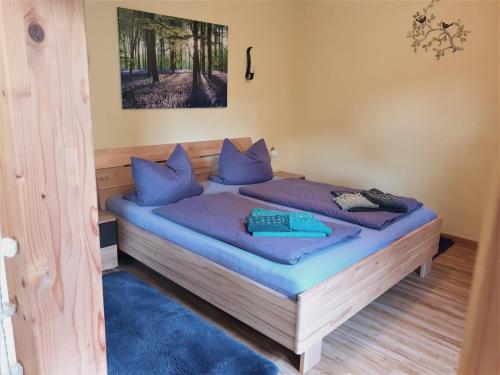 a bedroom with a bed with blue pillows at Ferienwohnung Bär in Vohenstrauß