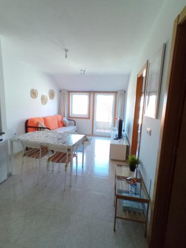 a living room with a couch and a table at Ático con vistas a la ría de Arosa in Rianjo