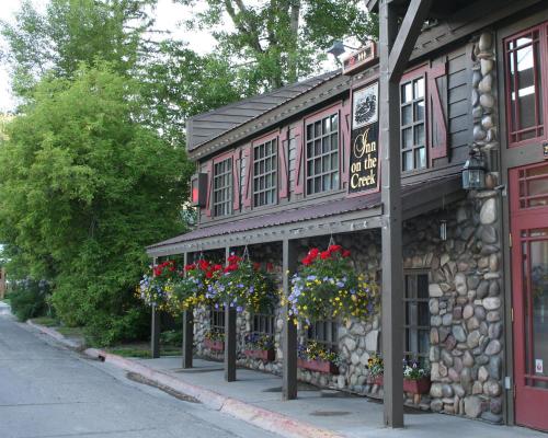 a building with flowers in front of it at Inn on The Creek in Jackson