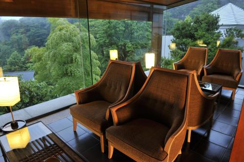 a waiting room with chairs and a large window at Gora Kadan in Hakone