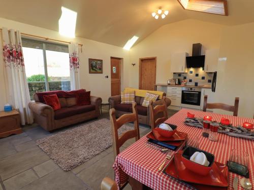 a living room with a couch and a table and chairs at Swallow cottage, Over Kellet in Over Kellet
