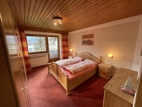 a small bedroom with a bed and a window at Haus Kropfa in Hippach